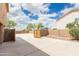 Spacious driveway and gate access to the backyard, surrounded by block wall fencing at 11419 E Ellis St, Mesa, AZ 85207