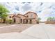 Well maintained two-story home with a concrete driveway and desert landscaping in the front at 11419 E Ellis St, Mesa, AZ 85207