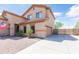 Charming home with neat landscaping, a two-car garage, and a welcoming facade at 11419 E Ellis St, Mesa, AZ 85207