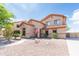 Welcoming two-story home featuring desert landscaping and a quaint walkway to the front door at 11419 E Ellis St, Mesa, AZ 85207
