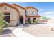 Charming two-story home with desert landscaping, gravel yard, and walkway to the front entrance at 11419 E Ellis St, Mesa, AZ 85207