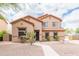 Charming two-story home with desert landscaping and a well-manicured front yard and walkway at 11419 E Ellis St, Mesa, AZ 85207
