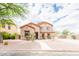 Charming two-story home with desert landscaping and a well-manicured front yard and walkway at 11419 E Ellis St, Mesa, AZ 85207