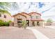 Charming two-story home with desert landscaping and a well-manicured front yard and walkway at 11419 E Ellis St, Mesa, AZ 85207