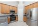 Kitchen features stainless steel appliances, granite countertops, and wood cabinets at 11419 E Ellis St, Mesa, AZ 85207