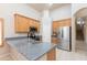 Updated kitchen with stainless steel appliances, granite countertops, and wood cabinets at 11419 E Ellis St, Mesa, AZ 85207