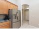 Kitchen details featuring wood cabinets, stainless steel refrigerator, and granite countertops at 11419 E Ellis St, Mesa, AZ 85207