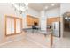 Bright kitchen boasts stainless steel appliances, wood cabinets, granite countertops, and a breakfast bar at 11419 E Ellis St, Mesa, AZ 85207