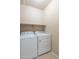 This laundry room features a pair of brand new, white, Whirlpool washing and drying machines at 11419 E Ellis St, Mesa, AZ 85207