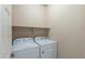 This laundry room features a pair of brand new, white, Whirlpool washing and drying machines at 11419 E Ellis St, Mesa, AZ 85207