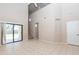 Spacious living room features tile flooring, a sliding glass door, and staircase access at 11419 E Ellis St, Mesa, AZ 85207