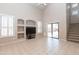 Bright living room boasts vaulted ceilings, custom built-ins, and sliding glass doors to the backyard at 11419 E Ellis St, Mesa, AZ 85207