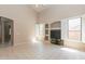 Living room with bright windows, tiled floor, and built-in shelves at 11419 E Ellis St, Mesa, AZ 85207