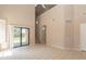 Spacious living room features stairs, glass sliding door, and tiled flooring at 11419 E Ellis St, Mesa, AZ 85207