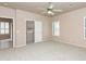 Carpeted main bedroom featuring a ceiling fan, plantation shutters, and closet access at 11419 E Ellis St, Mesa, AZ 85207