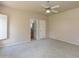 Spacious main bedroom featuring neutral colors, a ceiling fan and access to an ensuite bathroom at 11419 E Ellis St, Mesa, AZ 85207
