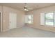 Main bedroom features two bright windows and carpeted flooring at 11419 E Ellis St, Mesa, AZ 85207