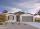 Charming single-story home with a two-car garage, desert landscaping, and a covered entryway at 12629 W Luxton Ln, Avondale, AZ 85323