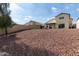 Large backyard with rock landscaping and partial view of the house exterior at 1421 E Charleston Ave, Phoenix, AZ 85022