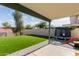 Beautiful backyard featuring a covered patio, artificial grass, and a trampoline at 1421 E Charleston Ave, Phoenix, AZ 85022
