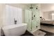 Bright bathroom with freestanding tub, glass enclosed shower, and modern fixtures at 1421 E Charleston Ave, Phoenix, AZ 85022