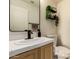 Charming bathroom features wood vanity, white countertops, and decorative shelving with plants at 1421 E Charleston Ave, Phoenix, AZ 85022