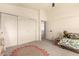 Bedroom with carpet flooring, a ceiling fan, and white closet doors at 1421 E Charleston Ave, Phoenix, AZ 85022