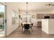 View of a dining room featuring modern lighting, backyard access, and a table set for Gathering meals at 1421 E Charleston Ave, Phoenix, AZ 85022
