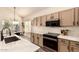 Well-lit kitchen boasts white countertops, stainless steel appliances, and plenty of cabinet space for storage at 1421 E Charleston Ave, Phoenix, AZ 85022