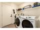 Convenient laundry room with modern washer, dryer, and storage shelves at 1421 E Charleston Ave, Phoenix, AZ 85022