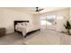 Relaxing main bedroom with carpet flooring, ceiling fan, and sliding glass doors to the backyard at 1421 E Charleston Ave, Phoenix, AZ 85022