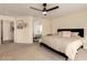 Cozy main bedroom with ceiling fan, carpet flooring, and ensuite bathroom at 1421 E Charleston Ave, Phoenix, AZ 85022