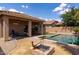 Private backyard showcasing a swimming pool, covered patio, and charming fire pit at 1461 W Brangus Way, San Tan Valley, AZ 85143