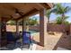 Covered patio looks out to a pool with an outdoor fire pit at 1461 W Brangus Way, San Tan Valley, AZ 85143