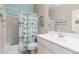 Bathroom with a single sink vanity, shower over tub, and coastal decor at 1461 W Brangus Way, San Tan Valley, AZ 85143
