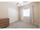 Bright bedroom features a ceiling fan, closet, window, and neutral carpet at 1461 W Brangus Way, San Tan Valley, AZ 85143