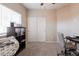 Neutral bedroom with carpet flooring, a desk, a printer on a shelf, and sliding closet doors at 1461 W Brangus Way, San Tan Valley, AZ 85143