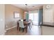 Dining area with a stylish light fixture and sliding glass doors for natural light at 1461 W Brangus Way, San Tan Valley, AZ 85143
