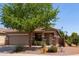 Charming single-story home with a well-maintained front yard and mature tree providing shade at 1461 W Brangus Way, San Tan Valley, AZ 85143