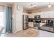Well-lit kitchen equipped with stainless steel appliances and ample cabinet space at 1461 W Brangus Way, San Tan Valley, AZ 85143