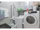 Practical laundry room equipped with washer, dryer and storage shelving at 1461 W Brangus Way, San Tan Valley, AZ 85143