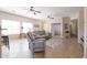Living room with plush seating, ceiling fans, ample natural light, and tile flooring throughout at 1461 W Brangus Way, San Tan Valley, AZ 85143