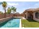 Beautiful backyard featuring a refreshing pool, artificial turf, and covered patio area at 1461 W Brangus Way, San Tan Valley, AZ 85143