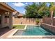 Beautiful backyard pool with travertine tile surround and rock landscaping at 1461 W Brangus Way, San Tan Valley, AZ 85143
