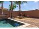 Beautiful backyard pool with an outdoor fire pit and rock landscaping at 1461 W Brangus Way, San Tan Valley, AZ 85143