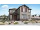 Charming two-story home featuring a mix of stucco and stone, complemented by desert landscaping at 14669 W Sand Hills Rd, Surprise, AZ 85387