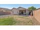 Spacious backyard with a covered patio, ideal for relaxation and outdoor activities at 15453 W Shangri La Rd, Surprise, AZ 85379