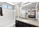 Bright bathroom featuring a tub, shower, and a granite countertop vanity with dark wood cabinets at 15453 W Shangri La Rd, Surprise, AZ 85379