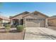 Lovely single-story home with well-maintained desert landscaping and a two-car garage at 15453 W Shangri La Rd, Surprise, AZ 85379