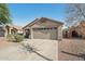 View of the two-car garage and the driveway of this lovely single-story home at 15453 W Shangri La Rd, Surprise, AZ 85379